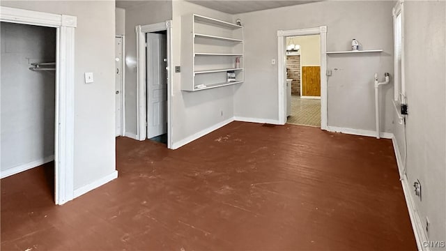 unfurnished bedroom with a closet and baseboards