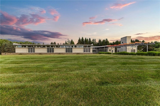 10289-10288 Whispering Wind Trl, Corning, NY 14830 - back of property at dusk featuring a lawn