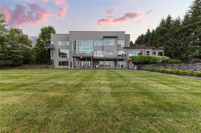 10289-10288 Whispering Wind Trl, Corning, NY 14830 - back of house at dusk featuring a lawn and a balcony