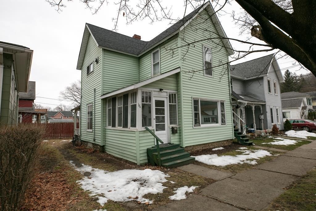 exterior space featuring a chimney, entry steps, and fence
