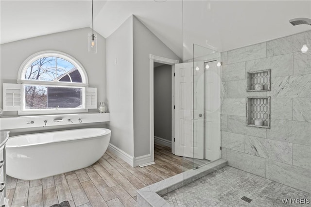 4369 Autumn Ln, Lewiston, NY 14092 - bathroom with a freestanding tub, lofted ceiling, a tile shower, baseboards, and wood tiled floor