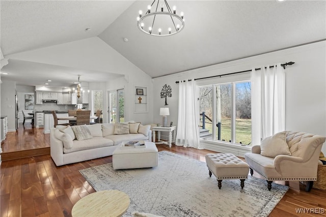 4369 Autumn Ln, Lewiston, NY 14092 - living room with high vaulted ceiling, a notable chandelier, and hardwood / wood-style flooring