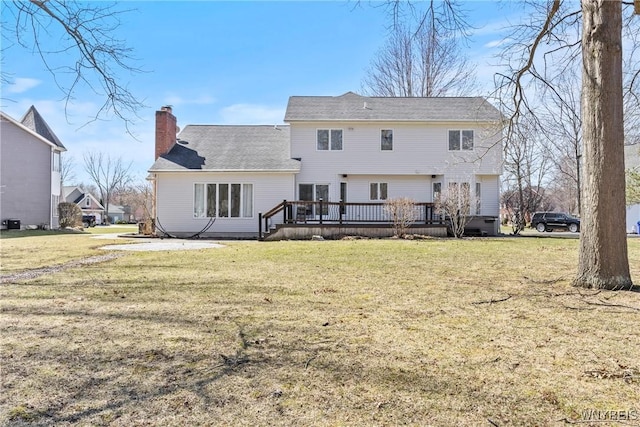 4369 Autumn Ln, Lewiston, NY 14092 - rear view of house featuring a chimney, a wooden deck, and a yard