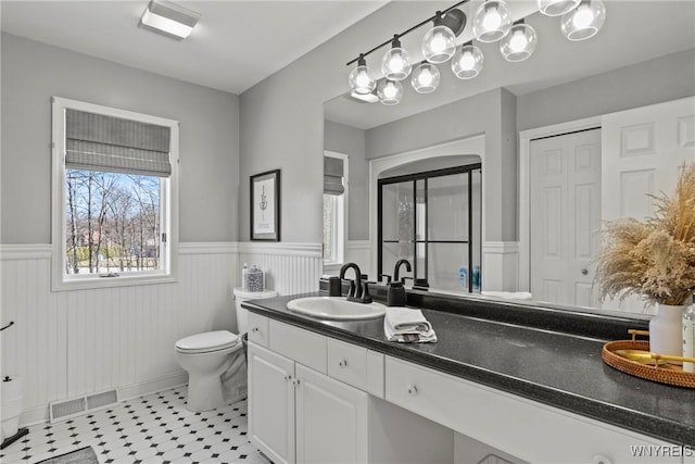 4369 Autumn Ln, Lewiston, NY 14092 - bathroom with visible vents, toilet, vanity, and wainscoting