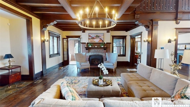 living room featuring baseboards, wood finished floors, beam ceiling, and an inviting chandelier