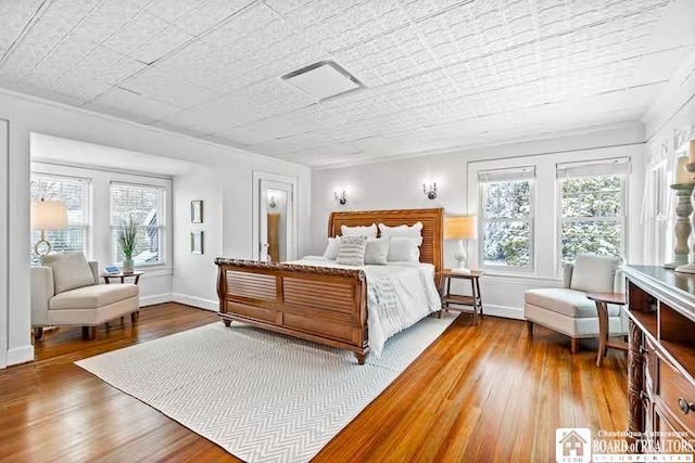 bedroom featuring wood-type flooring and baseboards