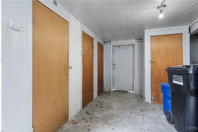 hall featuring unfinished concrete flooring