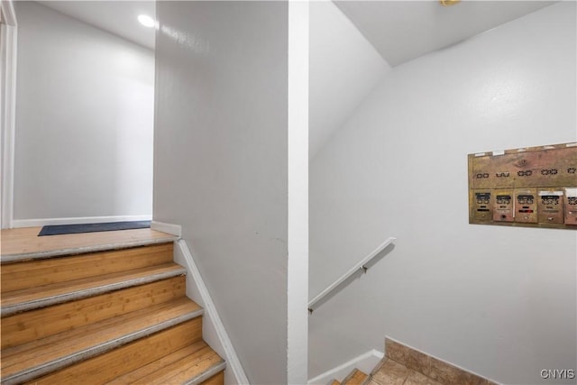 staircase featuring baseboards