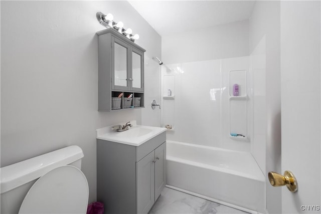 bathroom featuring marble finish floor, vanity, toilet, and shower / bathing tub combination