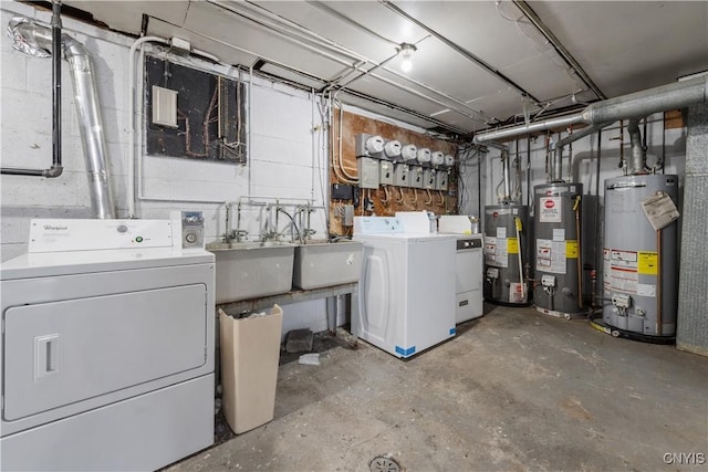 unfinished basement with a sink, gas water heater, and separate washer and dryer