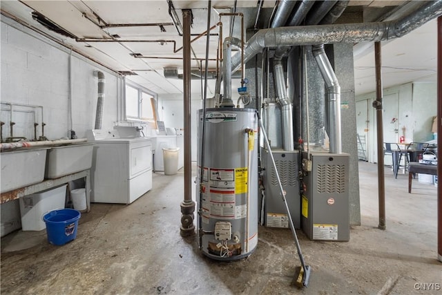 below grade area featuring water heater, heating unit, concrete block wall, and washer and clothes dryer