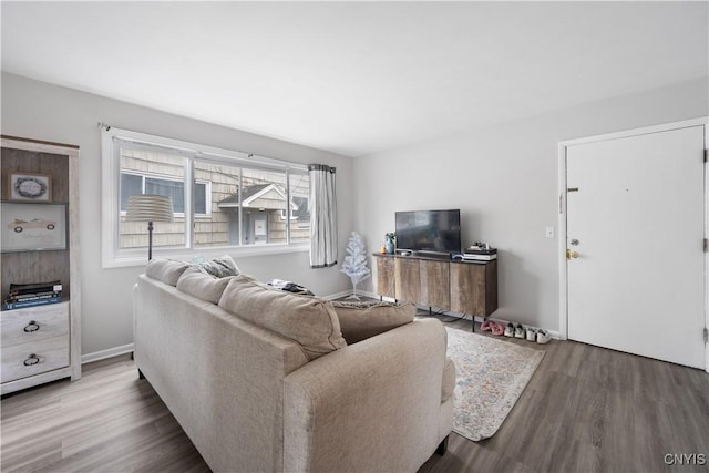 living area featuring baseboards and wood finished floors