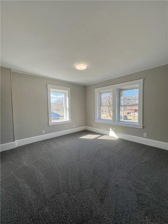 1230 Lake St, Elmira-City, NY 14901 - unfurnished room with baseboards, ornamental molding, and dark colored carpet