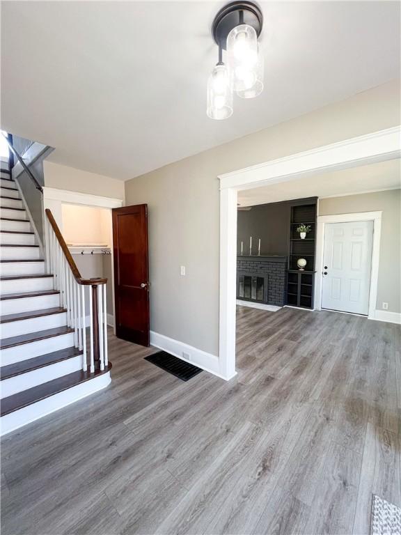 1230 Lake St, Elmira-City, NY 14901 - interior space featuring baseboards, a fireplace, wood finished floors, and stairway