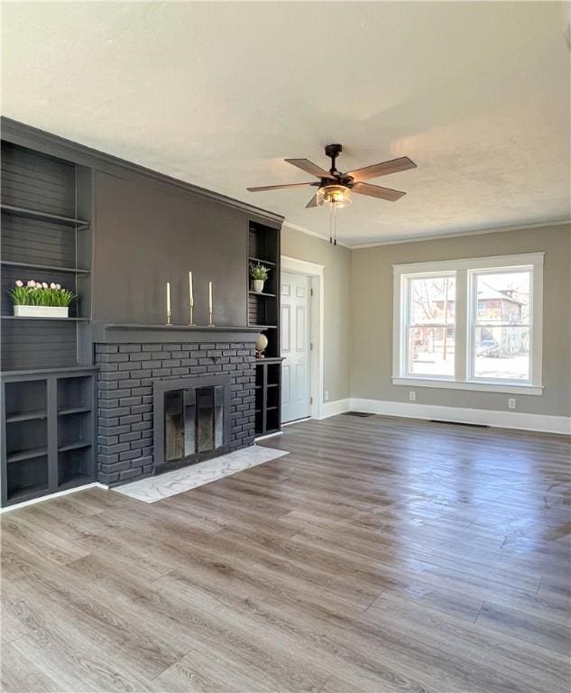 1230 Lake St, Elmira-City, NY 14901 - unfurnished living room with crown molding, a brick fireplace, baseboards, ceiling fan, and wood finished floors
