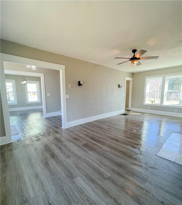 1230 Lake St, Elmira-City, NY 14901 - empty room featuring baseboards, a ceiling fan, wood finished floors, and a healthy amount of sunlight
