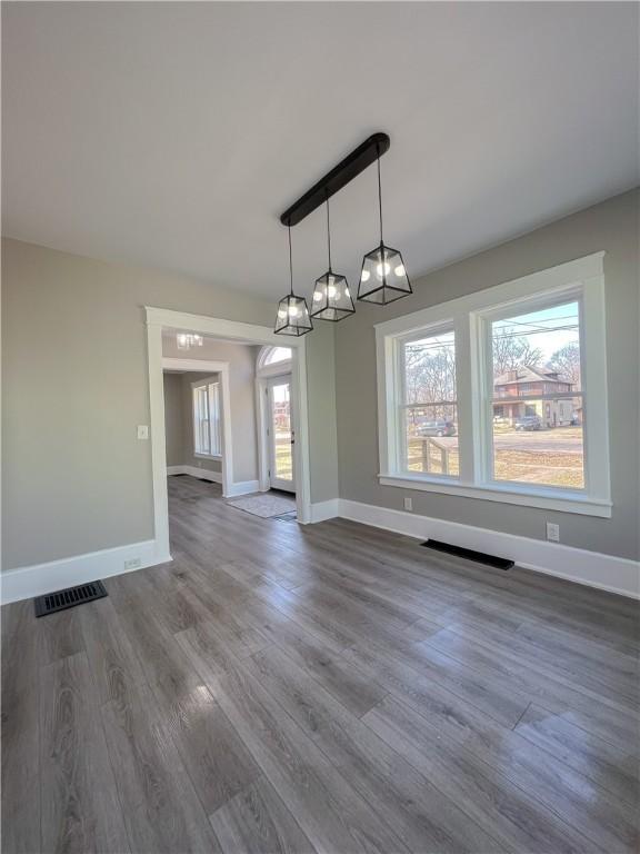 1230 Lake St, Elmira-City, NY 14901 - unfurnished dining area featuring baseboards, dark wood-style floors, visible vents, and a chandelier