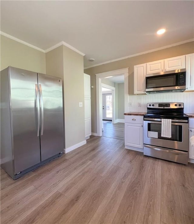 1230 Lake St, Elmira-City, NY 14901 - kitchen featuring white cabinets, stainless steel appliances, light wood-type flooring, and ornamental molding