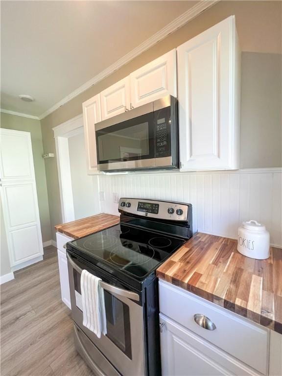 1230 Lake St, Elmira-City, NY 14901 - kitchen with crown molding, white cabinetry, light wood-style flooring, stainless steel appliances, and wood counters