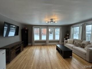 140 Riverside Dr, Utica, NY 13502 - living room featuring light wood-style flooring and a chandelier