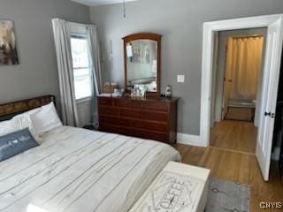 140 Riverside Dr, Utica, NY 13502 - bedroom with baseboards and wood finished floors