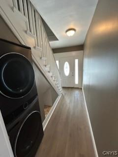 140 Riverside Dr, Utica, NY 13502 - interior space with stacked washer and dryer, baseboards, wood finished floors, and stairs