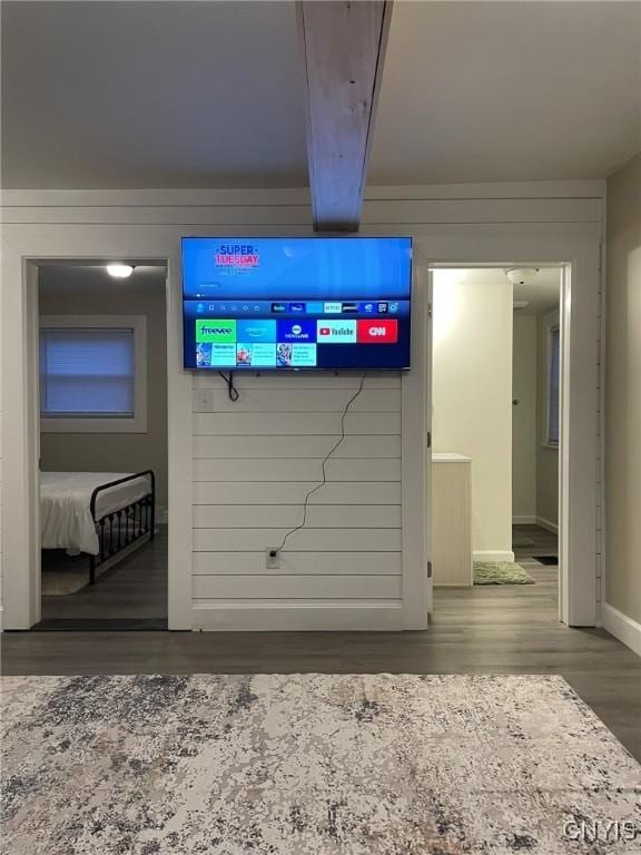 140 Riverside Dr, Utica, NY 13502 - interior details featuring baseboards, wood finished floors, wooden walls, and beamed ceiling