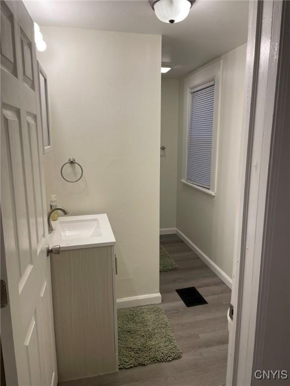 140 Riverside Dr, Utica, NY 13502 - bathroom featuring wood finished floors, vanity, baseboards, and visible vents