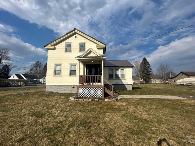 140 Riverside Dr, Utica, NY 13502 - traditional home with a front lawn and a metal roof