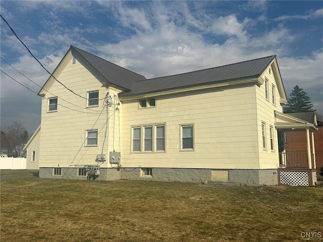 140 Riverside Dr, Utica, NY 13502 - view of side of home with a lawn and a metal roof