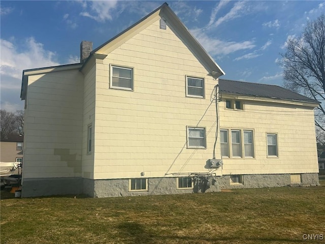 140 Riverside Dr, Utica, NY 13502 - view of home's exterior with a chimney and a yard