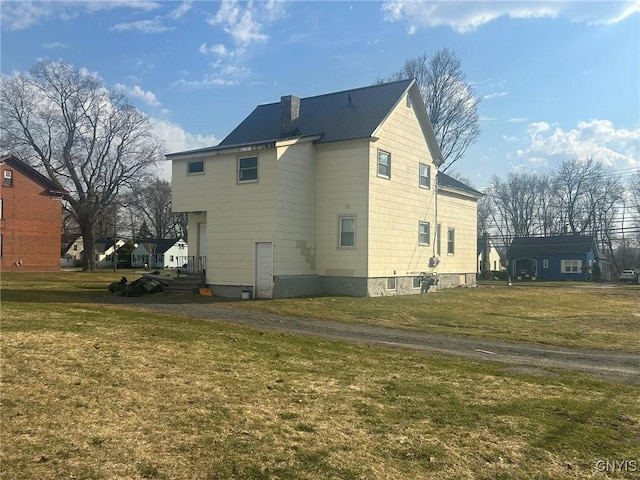 140 Riverside Dr, Utica, NY 13502 - back of property with a lawn and a metal roof