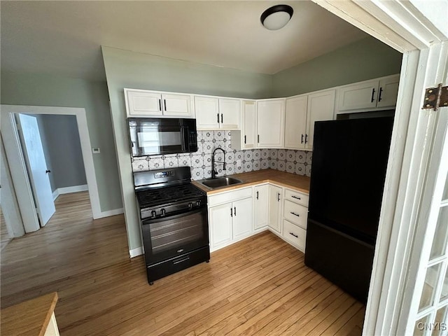 140 Riverside Dr, Utica, NY 13502 - kitchen featuring black appliances, white cabinets, light wood finished floors, tasteful backsplash, and light countertops