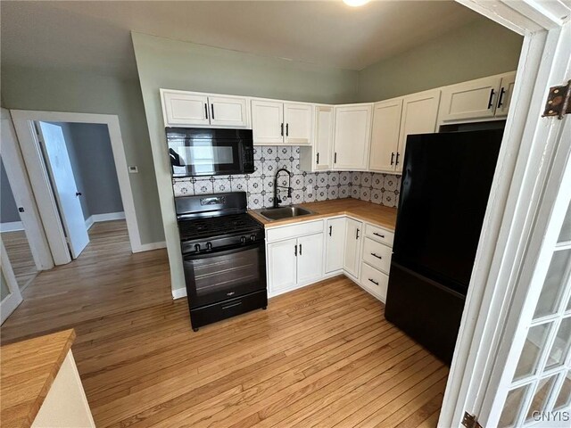 140 Riverside Dr, Utica, NY 13502 - kitchen with black appliances, white cabinetry, and light wood-type flooring