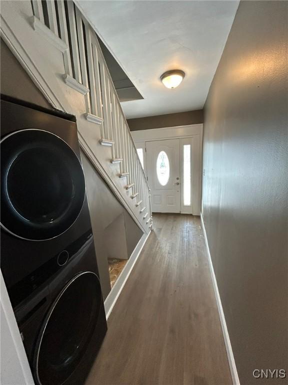 140 Riverside Dr, Utica, NY 13502 - entrance foyer featuring estacked washer and dryer, wood finished floors, and stairway