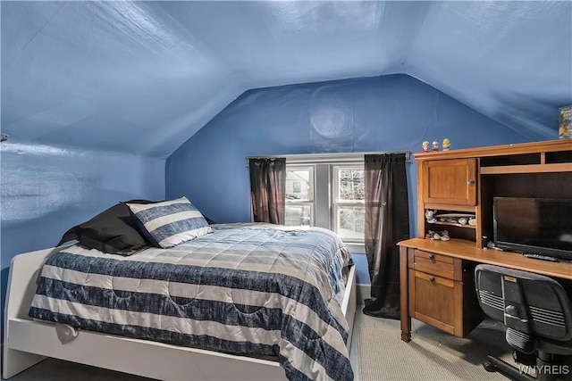 bedroom featuring light colored carpet and vaulted ceiling