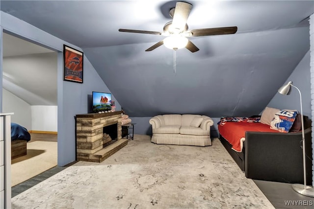 bonus room featuring a stone fireplace, a ceiling fan, and lofted ceiling