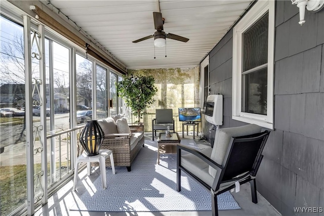 sunroom with ceiling fan and outdoor lounge area