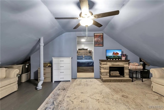 bedroom with ceiling fan, vaulted ceiling, and wood finished floors