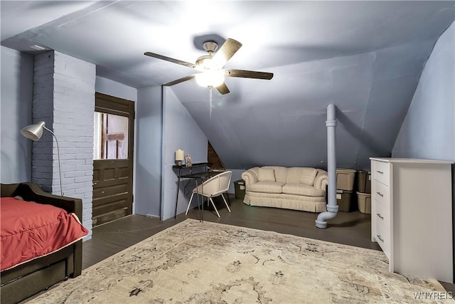 bedroom with ceiling fan, wood finished floors, and vaulted ceiling