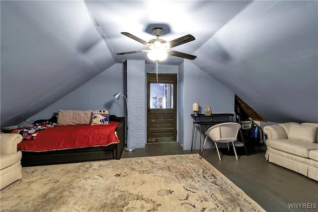 bedroom featuring a ceiling fan, wood finished floors, and vaulted ceiling