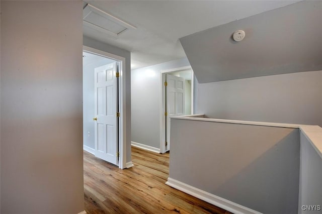 88 Walton St, Alexandria, NY 13607 - corridor with baseboards, an upstairs landing, wood finished floors, and attic access