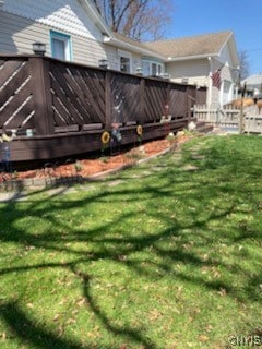 view of yard with fence and a wooden deck