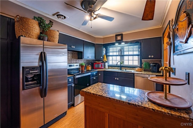 208 Eatonville Rd, Little Falls, NY 13365 - kitchen with stainless steel appliances, dark stone countertops, decorative backsplash, ceiling fan, and crown molding