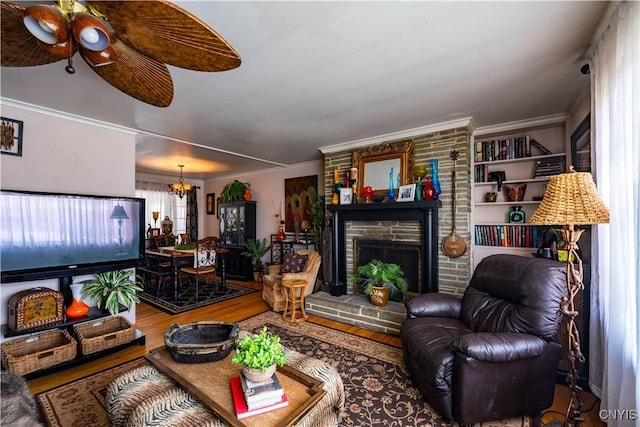 208 Eatonville Rd, Little Falls, NY 13365 - living area with wood finished floors, a chandelier, a large fireplace, ceiling fan, and crown molding