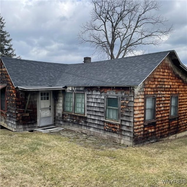 6235 SW Shr, Canadice, NY 14471 - view of front of home featuring roof with shingles, a chimney, and a front yard