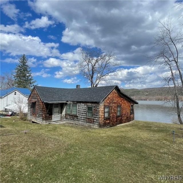 6235 SW Shr, Canadice, NY 14471 - view of front facade with a water view, a front lawn, and roof with shingles
