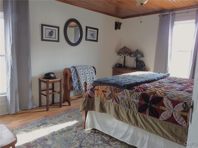 bedroom with wood ceiling and wood finished floors