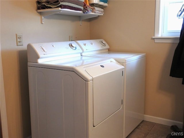 washroom with baseboards, independent washer and dryer, laundry area, and tile patterned flooring