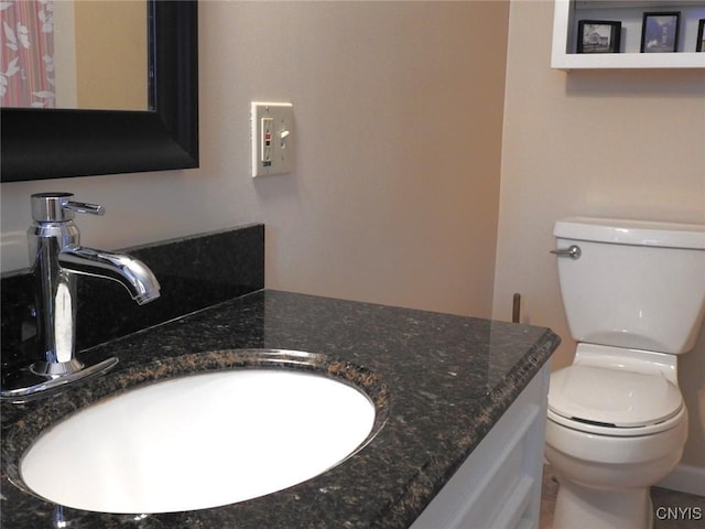 bathroom with toilet and vanity